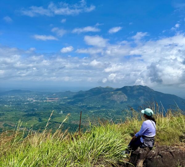 girl sitting in chembra peak top